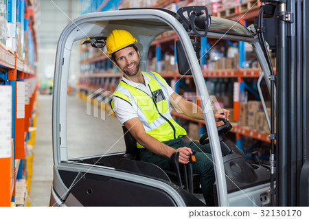 Male worker using forklift 32130170
