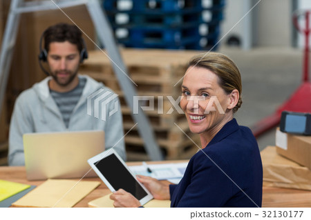 Portrait of warehouse manager using digital tablet Portrait of warehouse manager using digital tablet 32130177