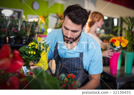 Male florist arranging flower bouquet 32130435