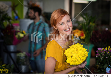 Portrait of female florist holding bouquet of flower 32130581