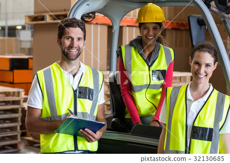 Portrait of warehouse workers and forklift driver 32130685