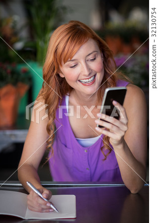 Female florist using mobile phone 32130754