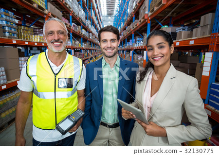 Portrait of warehouse team standing with digital tablet and barcode scanner 32130775