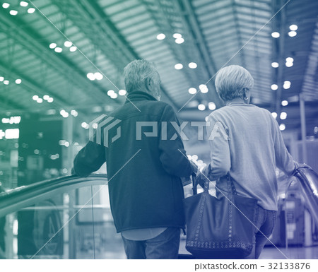 Lovely senior couple tourists on escalator 32133876