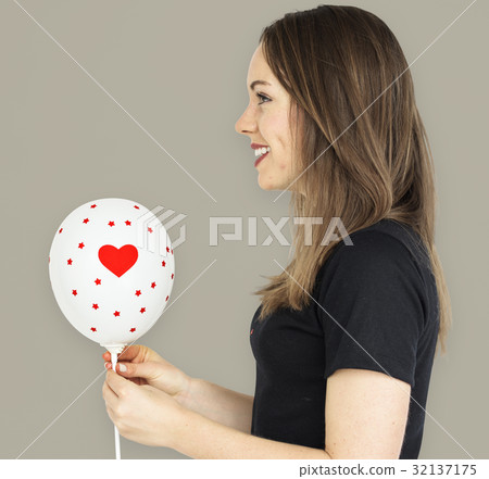 Young girl smiling holding a balloon 32137175