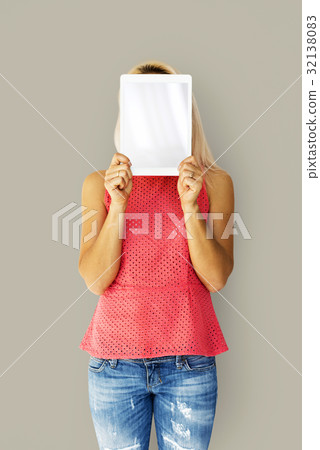 Woman holding tablet cover her face Woman holding tablet cover her face 32138083
