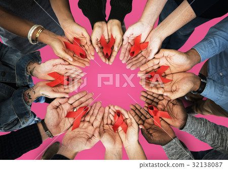Group of hands holding red ribbon stop drugs and HIV/AIDS awareness Group of hands holding red ribbon stop drugs and HIV/AIDS awareness 32138087