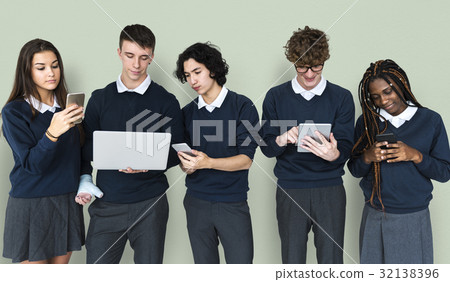 Diverse Group Of Students Using Electronic Devices Diverse Group Of Students Using Electronic Devices 32138396
