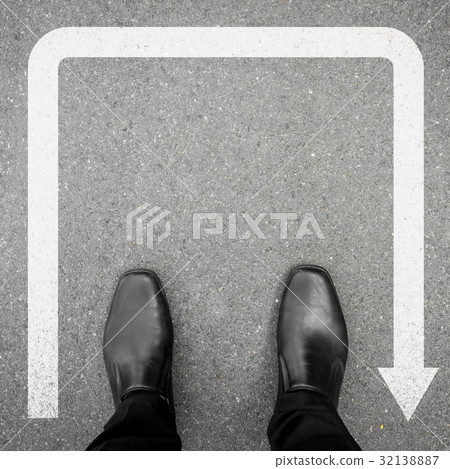 Black shoes standing at u turn sign Black shoes standing at u turn sign 32138887