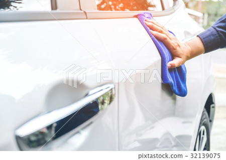 man cleaning car with microfiber cloth white car man cleaning car with microfiber cloth white car 32139075