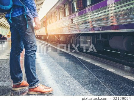 Traveler man  waits train on railway platform 32139094