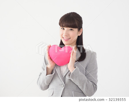 Business woman with pink heart Business woman with pink heart 32139355