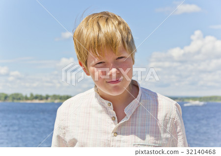 Portrait of squint blond boy near river Portrait of squint blond boy near river 32140468
