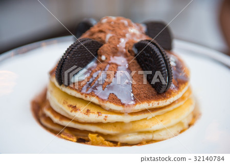 Pancake decorate with chocolate powder and cookie 32140784