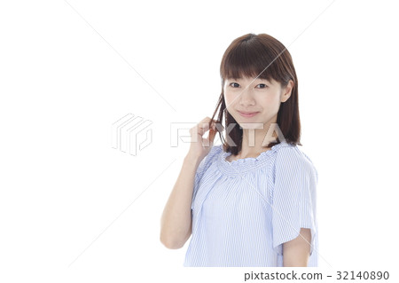 A woman touching her hair A woman touching her hair 32140890