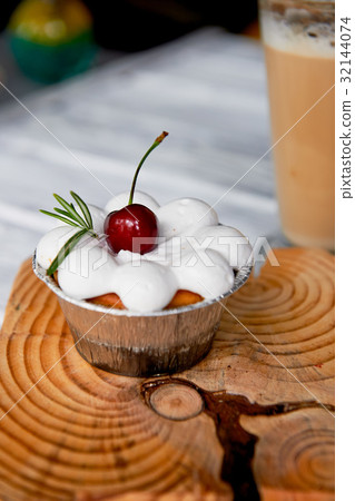 cheesecake with cherries in tartlets.On wooden cheesecake with cherries in tartlets.On wooden 32144074