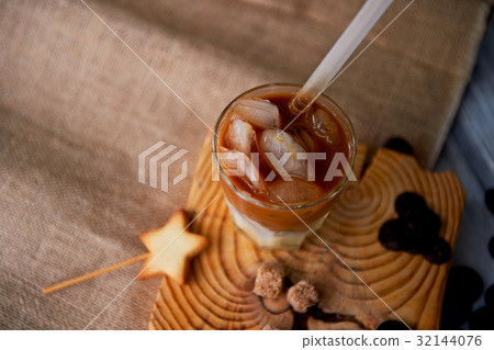The Hong Kong iced coffee in a glass, with a straw The Hong Kong iced coffee in a glass, with a straw 32144076