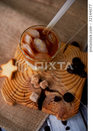The Hong Kong iced coffee in a glass, with a straw The Hong Kong iced coffee in a glass, with a straw 32144077