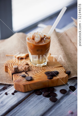 The Hong Kong iced coffee in a glass, with a straw The Hong Kong iced coffee in a glass, with a straw 32144078