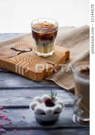 The Hong Kong iced coffee in a glass, with a straw The Hong Kong iced coffee in a glass, with a straw 32144079