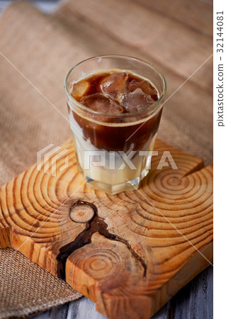 The Hong Kong iced coffee in a glass, with a straw The Hong Kong iced coffee in a glass, with a straw 32144081