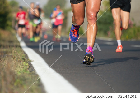 Marathon running race, people feet on city road 32144201