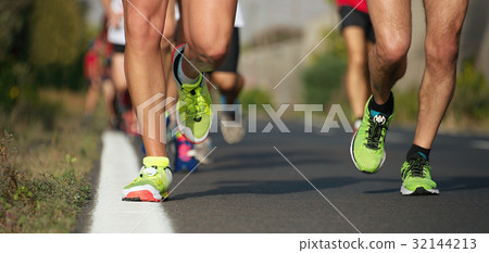 Marathon running race, people feet on city road 32144213