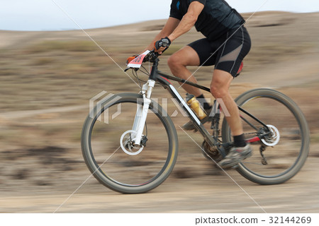 Motion blur of a mountain bike race 32144269