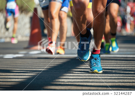 Marathon running race, people feet on city road Marathon running race, people feet on city road 32144287