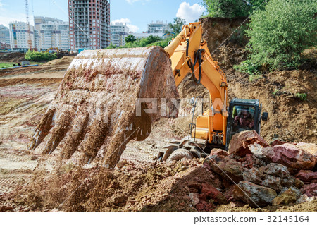 Excavator performs excavation work 32145164