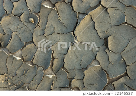Cracked dried mud in the summer. Cracked dried mud in the summer. 32146527