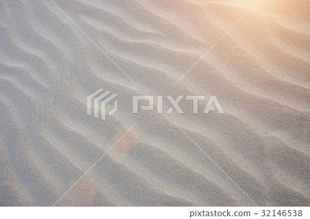Sand lines on the beach with sunlight. 32146538