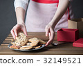 Housewife prepare gingerbread cookies as gift 32149521
