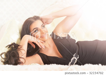 young woman lying on  bed  32154782