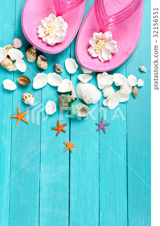 Pink flip flops and seashells 32156551