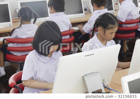 Kids are using computer in their classroom. 32156833