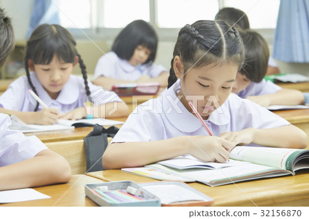 students are writting in class with concentration 32156870