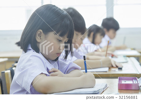 students are writing something on their notebook in class students are writing something on their notebook in class 32156881