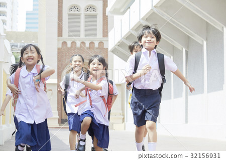 A photo of happy children with bags running to school A photo of happy children with bags running to school 32156931