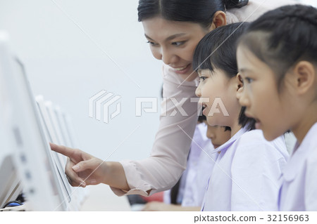 a teacher is pointing something for her students a teacher is pointing something for her students 32156963