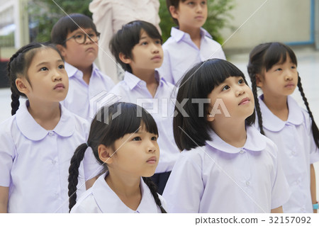 a photo of pupils listening and looking at something. a photo of pupils listening and looking at something. 32157092