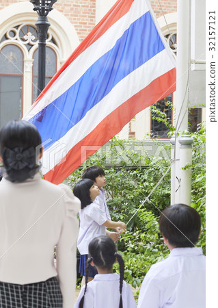 teacher and students are standing and looking at the flag teacher and students are standing and looking at the flag 32157121