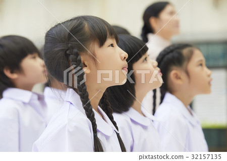 a picture of teacher and students concentrating on something. a picture of teacher and students concentrating on something. 32157135