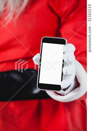 Santa claus showing mobile phone against white background 32163219