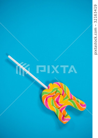 Lollypop on blue background 32163419