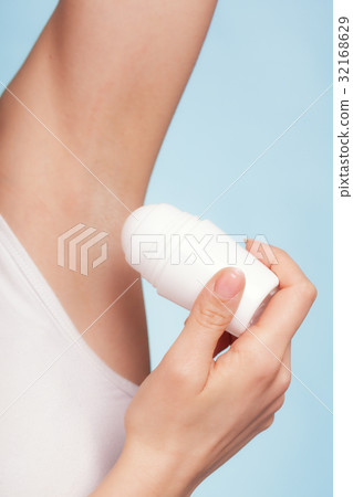 Girl applying stick deodorant in armpit. Skin care Girl applying stick deodorant in armpit. Skin care 32168629