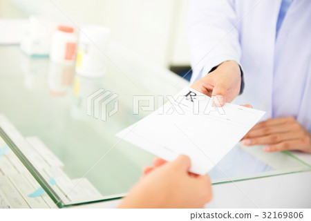 Customer giving prescription to pharmacist 32169806