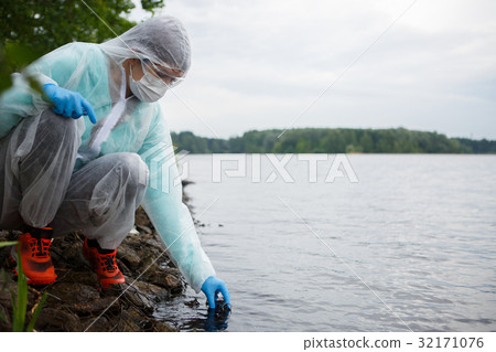 Young biologist takes water samples Young biologist takes water samples 32171076