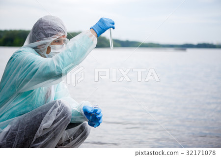 Biologist takes water for examination Biologist takes water for examination 32171078