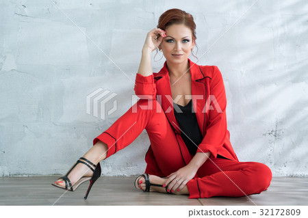 Pretty woman in fashionable red pantsuit in studio Pretty woman in fashionable red pantsuit in studio 32172809
